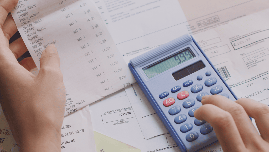 Paper receipts and expense reports illustrating traditional travel expense tracking