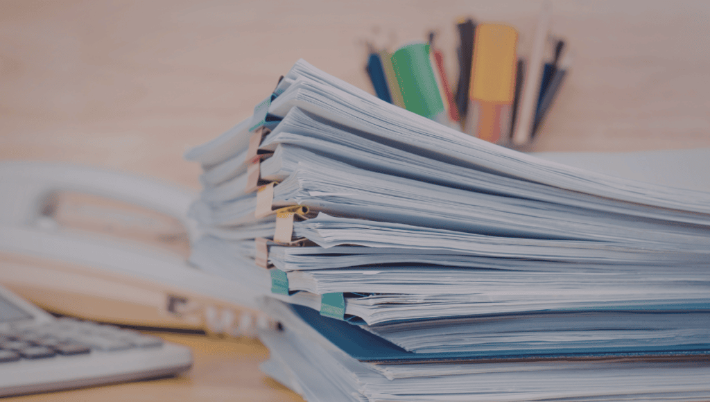 Multiple project documents and files representing scattered project information before using a project management app